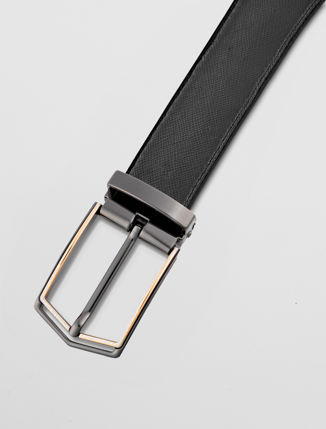 A sophisticated Carlo Fellini men's reversible leather belt, showcasing a stylish graphite and gold clamp buckle, is elegantly displayed on a plain white background.