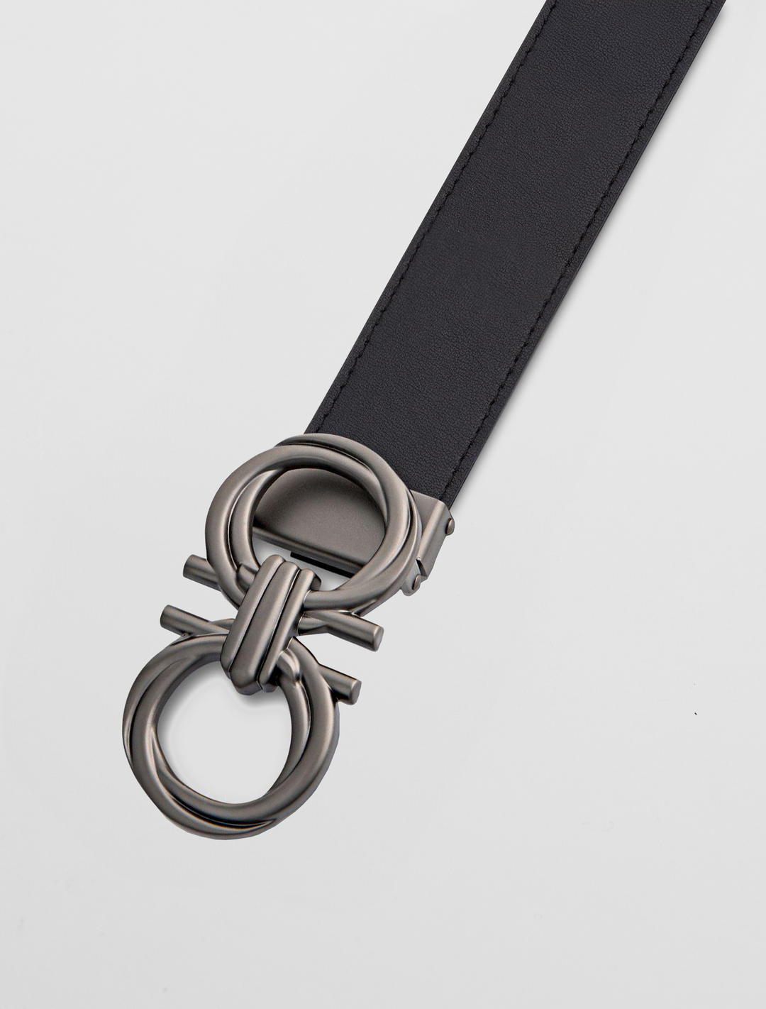 A sophisticated black belt made from genuine leather boasts a unique abstract graphite anchor buckle, beautifully displayed on a white background.