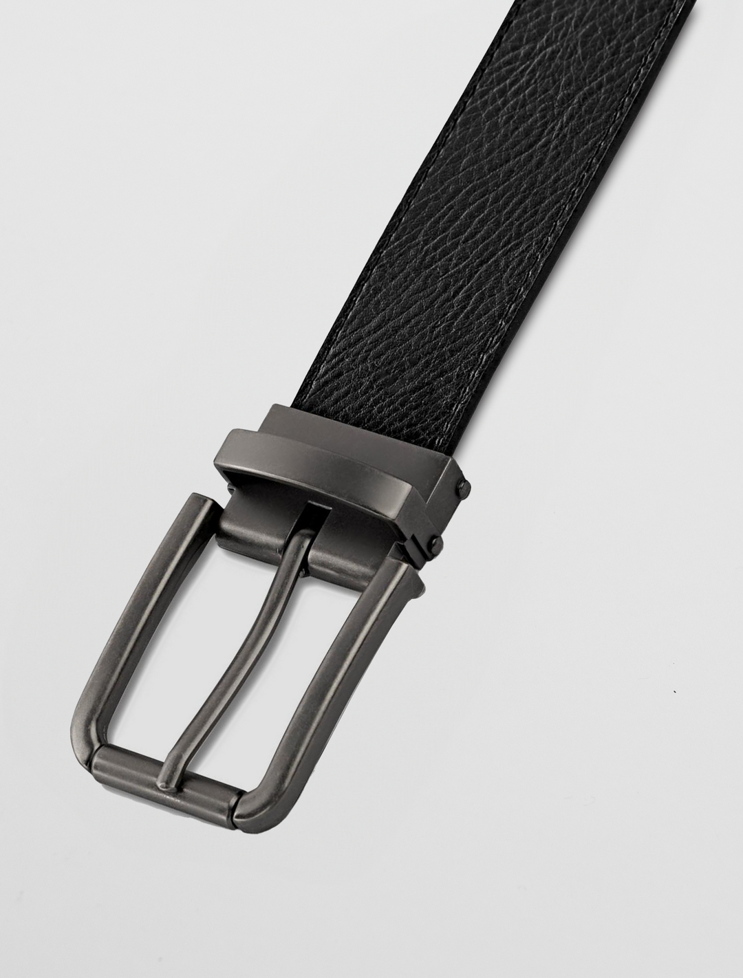 Close-up of the Carlo Fellini Men's Reversible Grain Leather Belt with a sleek graphite clamp buckle, set against a white background.