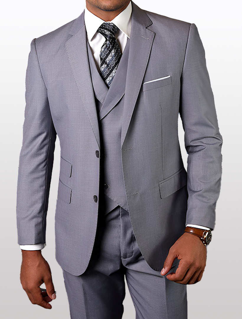 A person dressed in a Statement Mens Grey Modern Fit 100% Wool Vested Suit, complemented by a crisp white shirt and patterned tie, showcases a bronze-colored watch against a plain white background.