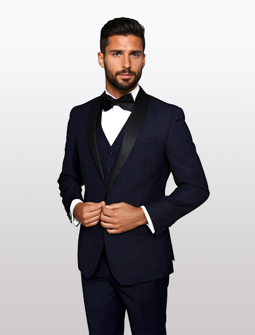 A man in a tailored fit, Statement Men's Navy with Black Lapel Vested 100% Wool Tuxedo stands against a plain white background, adjusting his jacket while wearing a black bow tie.