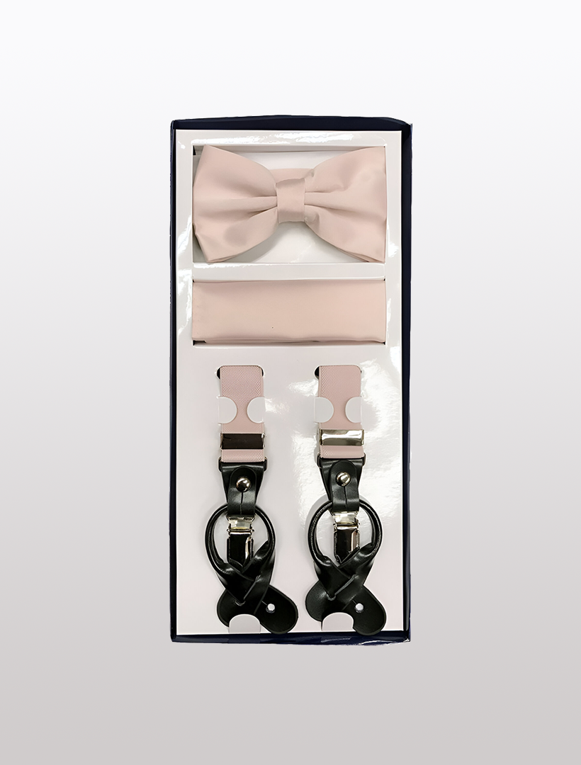 Introducing the Men's Skinny Pearl Pink 3 Piece Suspenders Set by Vesuvio Napoli, featuring a sophisticated light pink bow tie, a coordinating pocket square, and chic Y-back suspenders with metal clips. All items are elegantly packaged together in a stylish box.