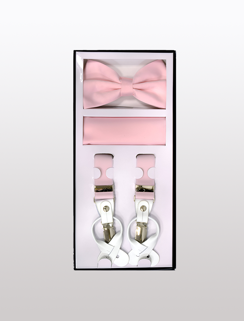 A stylish boxed set from Vesuvio Napoli, featuring their Men's Skinny Pink 3 Piece Suspenders Set—complete with a pink bow tie, a pink pocket square, and sleek white suspenders equipped with elastic button and clip convertible in an adjustable Y-back style—rests elegantly on a white background.