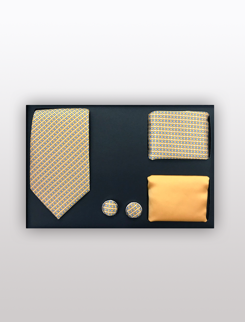 Discover the Men's Four Piece Yellow and Blue Diamond Patterned Gift Box by Vesuvio Napoli, featuring a slim fit tie, a matching pocket square, a solid yellow pocket square, and coordinating cufflinks on a black background. This elegantly arranged set is ideal for enhancing your formal ensemble on any occasion.