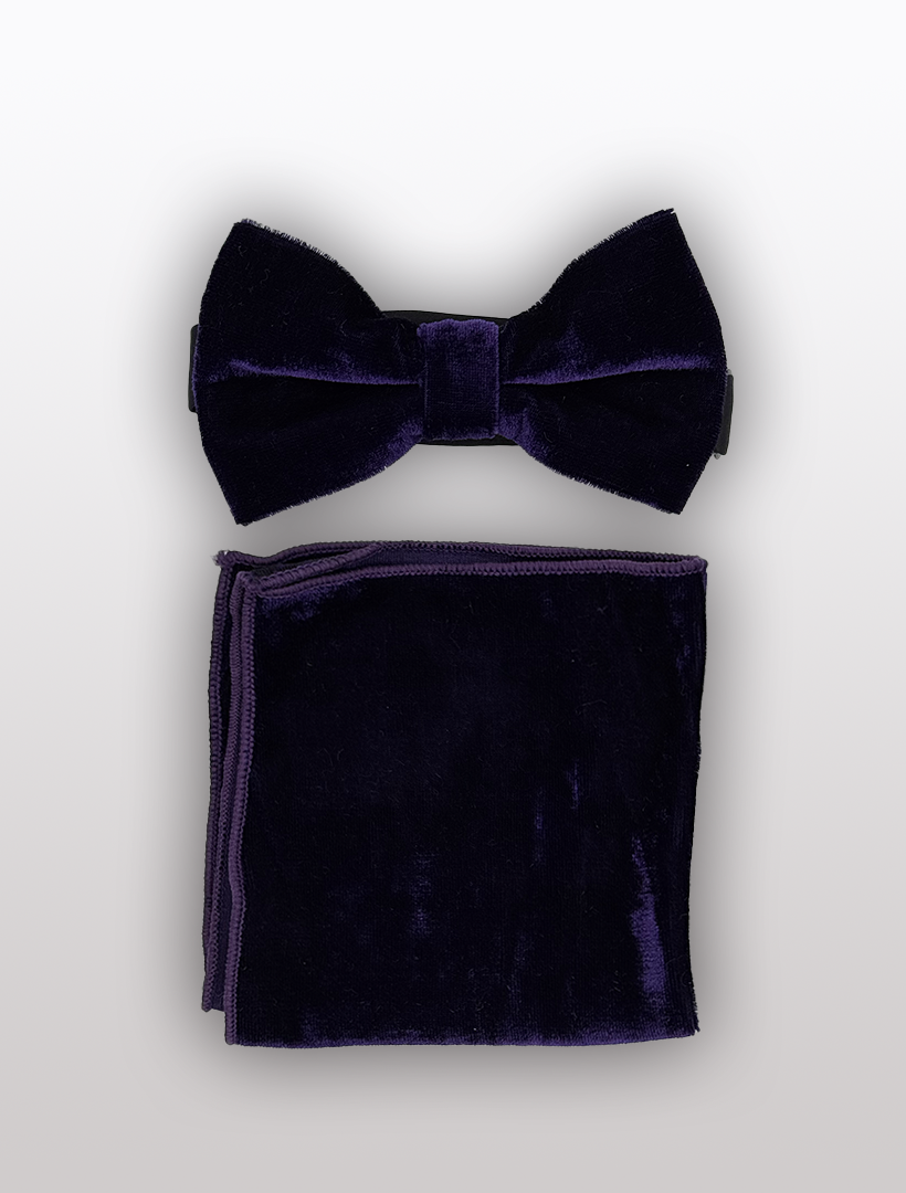 The Purple Velvet Bowtie and Hanky set by Ckl features a luxurious dark purple bow tie with an adjustable fit, accompanied by a matching pocket square, all displayed on a white background.
