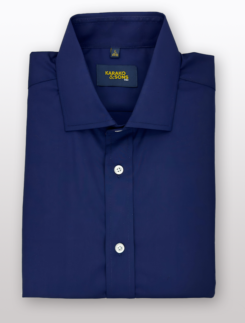 A folded Men's Navy Bamboo Wrinkle-Free Slim Fit Dress Shirt from Karako & Sons, featuring front button closure and a small logo tag inside the collar.