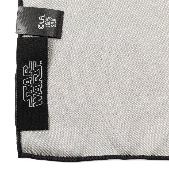 Close-up of a plain light gray Star Wars Tatooine Binary Sunset Pocket Square with a black logo label and a care tag reading 100% silk.