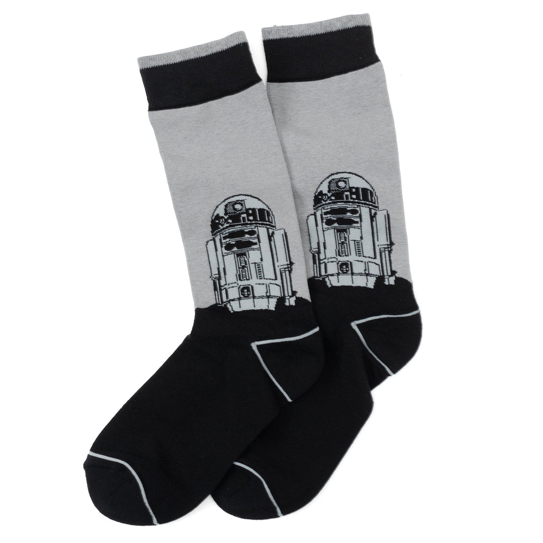 A pair of grey and black Star Wars Yoda, R2-D2, and C-3PO Dress Socks 3-Pack with Rebel Crest Lapel Pin Gift Set featuring a graphic of the character R2-D2.