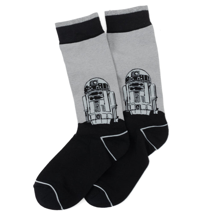A pair of grey and black Star Wars Yoda, R2-D2, and C-3PO Dress Socks 3-Pack with Rebel Crest Lapel Pin Gift Set featuring a graphic of the character R2-D2.