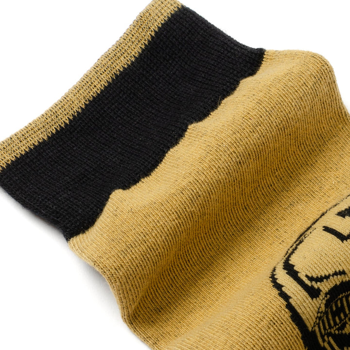 Close-up of a tan Star Wars Yoda, R2-D2, and C-3PO Dress Socks 3-Pack with Rebel Crest Lapel Pin Gift Set sock featuring a black top cuff and a partial black graphic of a character’s face.