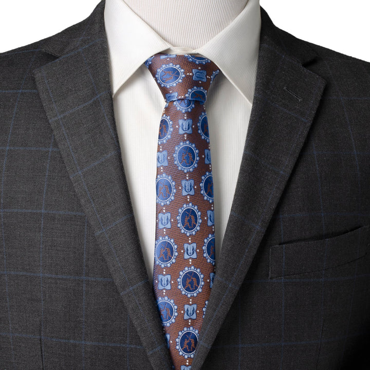 A Star Wars Obi-Wan Kenobi and Anakin Skywalker LIGHTSABER Battle Blue Tie in brown and blue with crossed lightsaber icons, worn with a white shirt and dark plaid blazer.