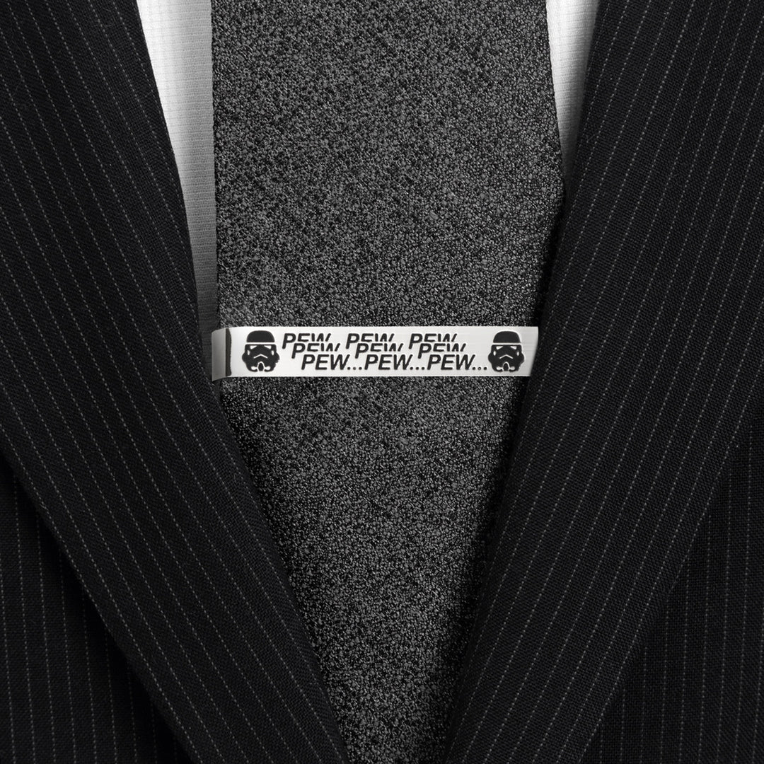Star Wars Stormtrooper Pew Pew Pew Tie Bar in silver-tone featuring Stormtrooper helmets and “PEW PEW PEW” text, pinned to a black textured necktie.