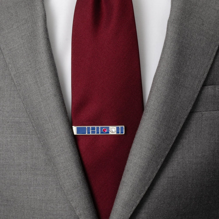 Star Wars R2-D2 Blue Tie Bar in silver worn on a maroon necktie with a grey suit jacket.