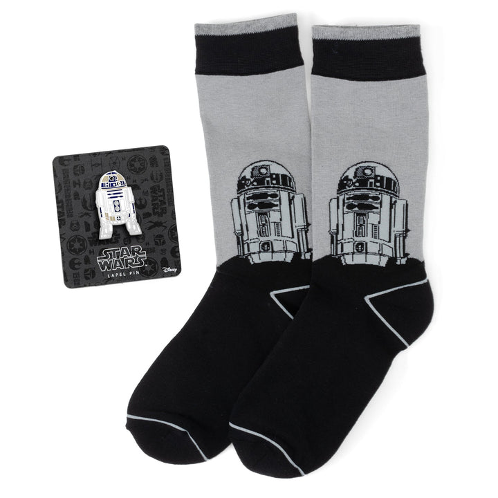 A pair of gray and black Star Wars R2-D2 Men’s Gray and Black Mod Dress Socks and Lapel Pin Gift Set by Cufflinks.com displayed with the pin attached to the branded card.