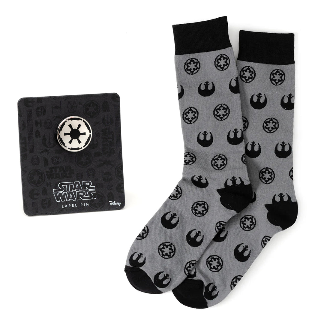 A pair of gray Star Wars Rebel Alliance Starbird Crest and Imperial Crest Dress Socks and Lapel Pin Gift Set featuring Imperial and Rebel crest patterns and a circular Imperial crest lapel pin.