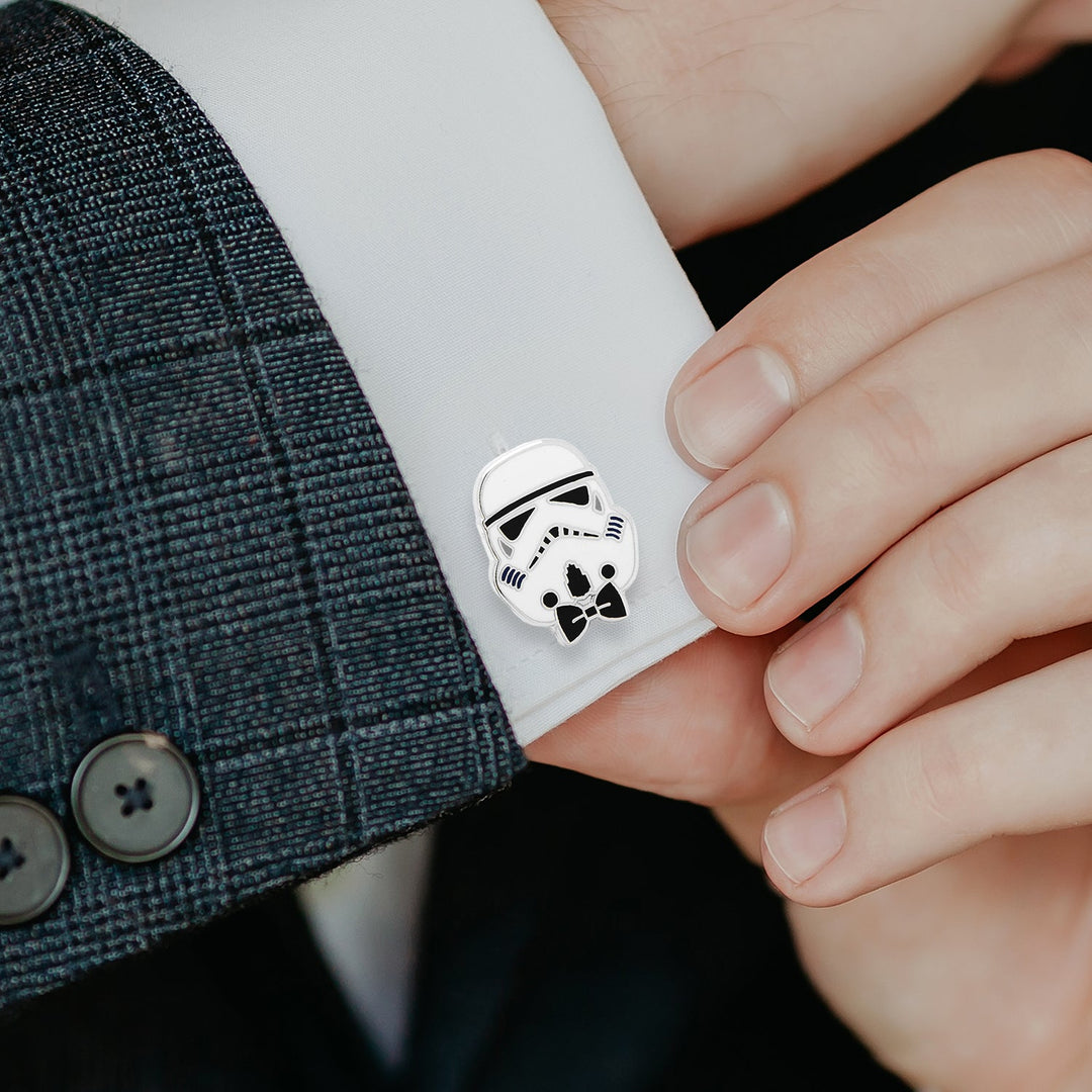 A silver Star Wars Stormtrooper with Bow Tie Cufflink, featuring a small black bow tie, attached to a white dress shirt cuff.