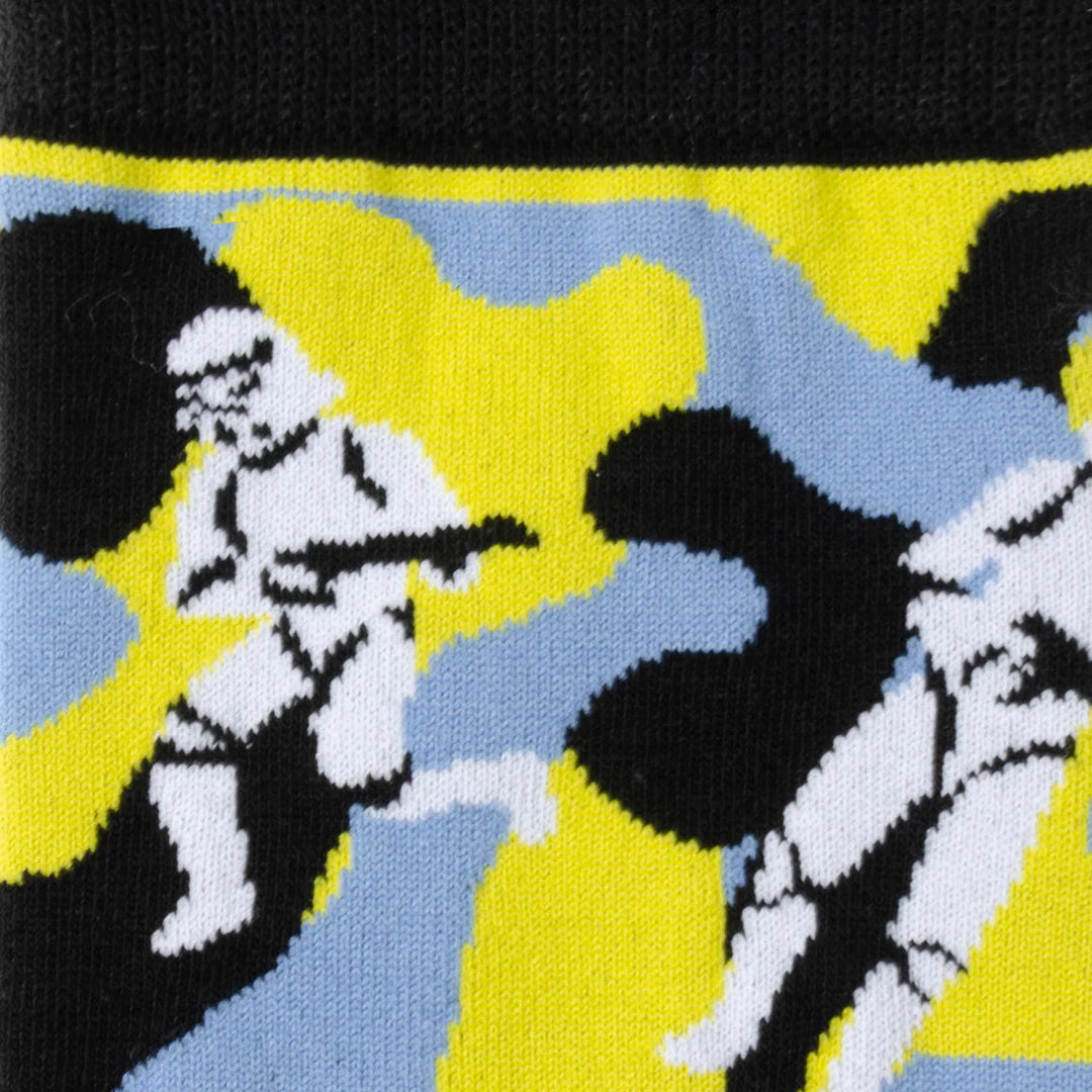 Close-up of knit fabric for the Star Wars Stormtrooper Yellow Camo Dress Socks and Lapel Pin Gift Set, featuring a repeating Stormtrooper camo pattern against a yellow, blue, and black background.