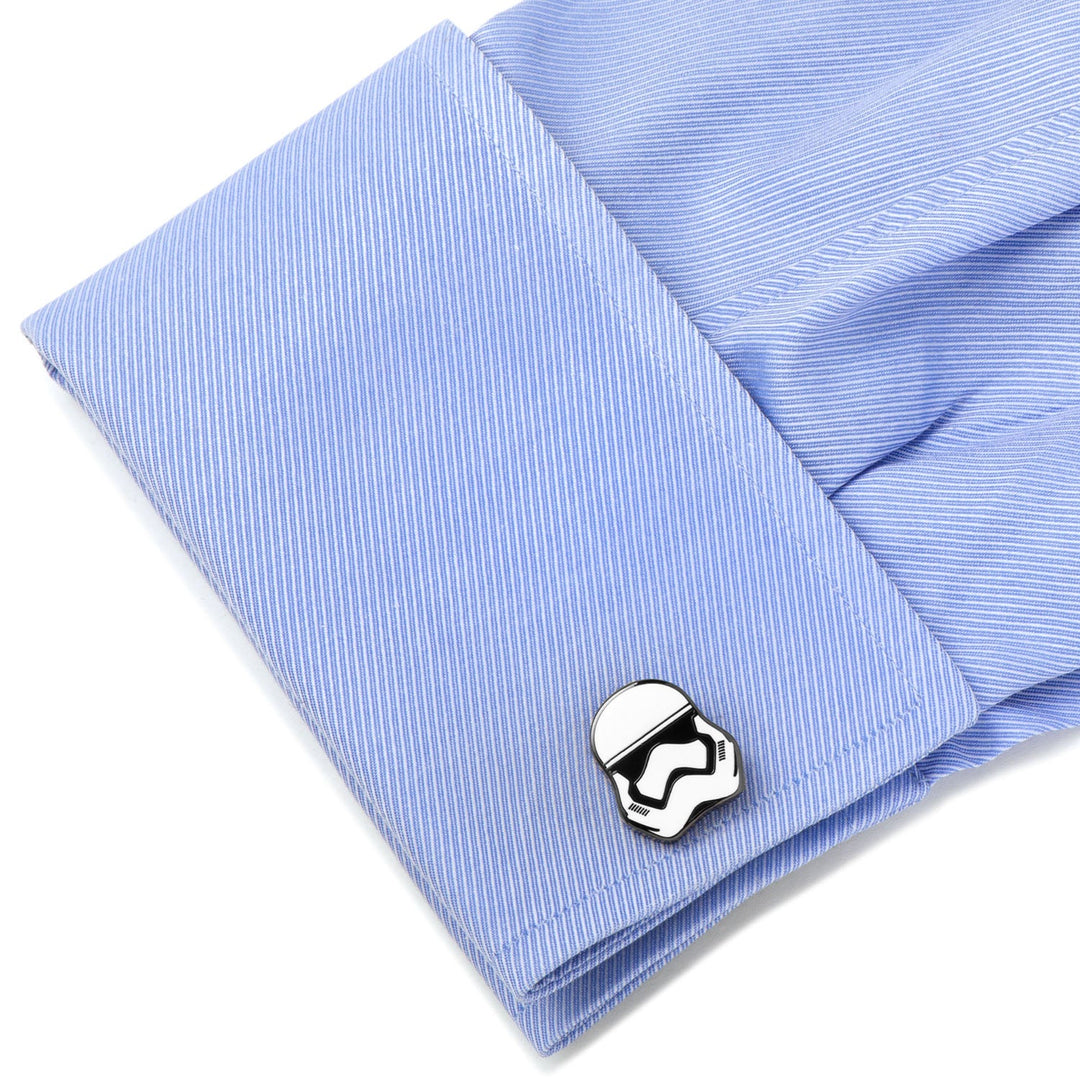 A silver-toned Star Wars Stormtrooper - Cufflinks piece fastened to the blue cuff of a dress shirt.