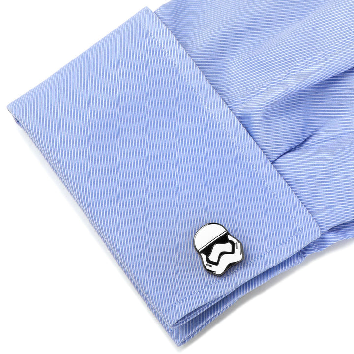 A silver-toned Star Wars Stormtrooper - Cufflinks piece fastened to the blue cuff of a dress shirt.