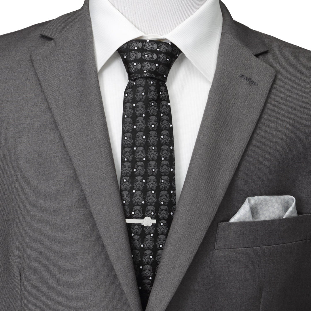 Star Wars Stormtrooper Dotted Black Tie featuring a repeating pattern of white helmets and dots, worn with a gray suit, white shirt, and silver tie bar.