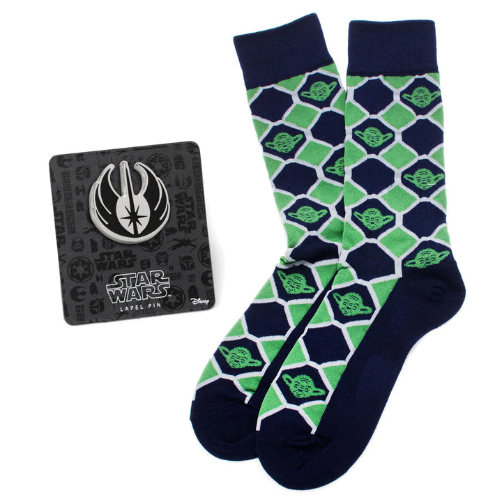 A pair of navy and green checkered Yoda socks next to a silver Jedi Order symbol lapel pin from the Star Wars Yoda Green and Navy Checkered Dress Socks and Jedi Crest Lapel Pin Gift Set by Cufflinks.com.