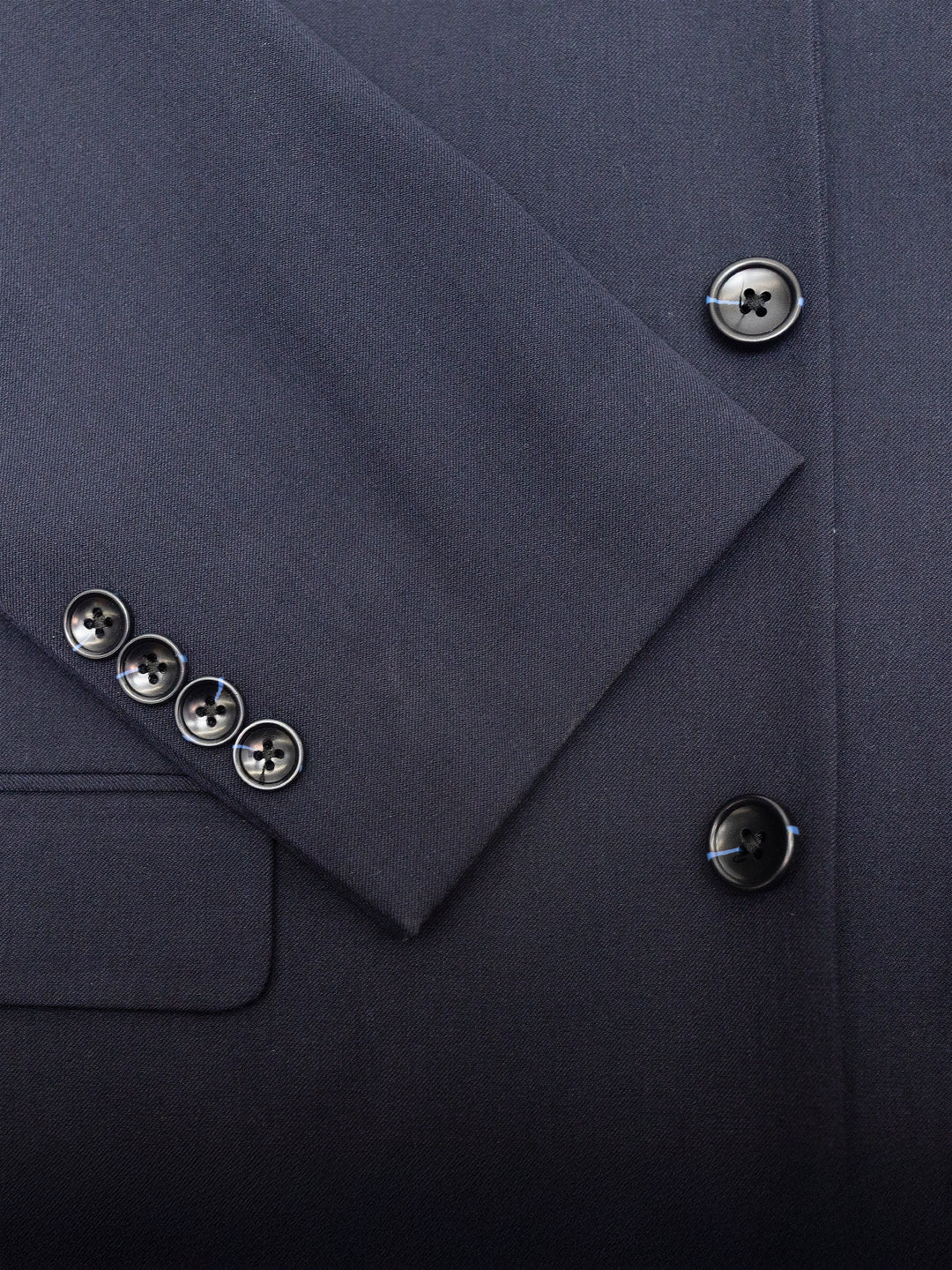 Close-up of a Mens Navy Suit by Karako Men, featuring buttons on the sleeve and front, ideal for a wedding or prom.