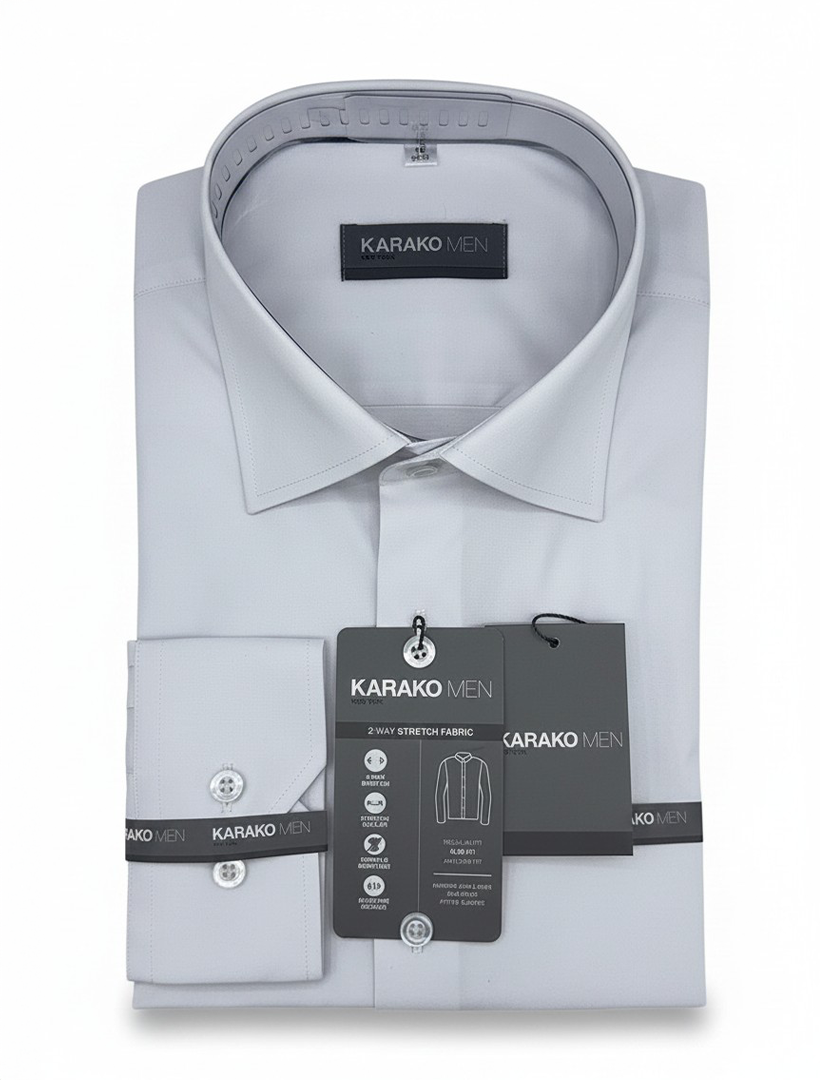 A folded white Karako Men dress shirt, still tagged and packaged, is displayed against a white background. This style is perfect for those looking for both Slim-fit and Classic-fit options.