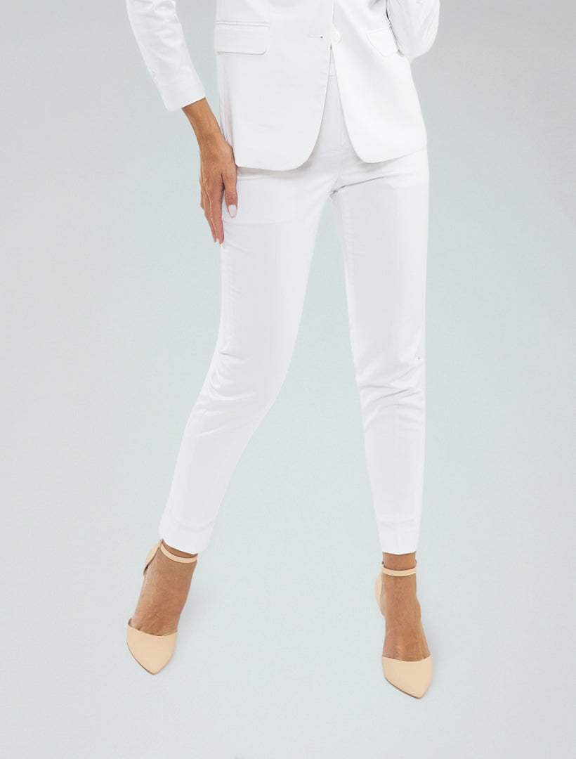 Model wears Couture 1910's Women's White Suit Separates Pants with beige pointed-toe heels, standing against a plain light background, one hand resting on her thigh.