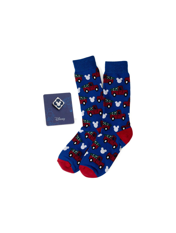 Disney Mickey Mouse Holiday Truck Navy Socks and Blue Lapel Pin Gift Set featuring navy socks with red Mickey Holiday Truck icons and white Mickey Mouse silhouettes, plus a matching lapel pin.