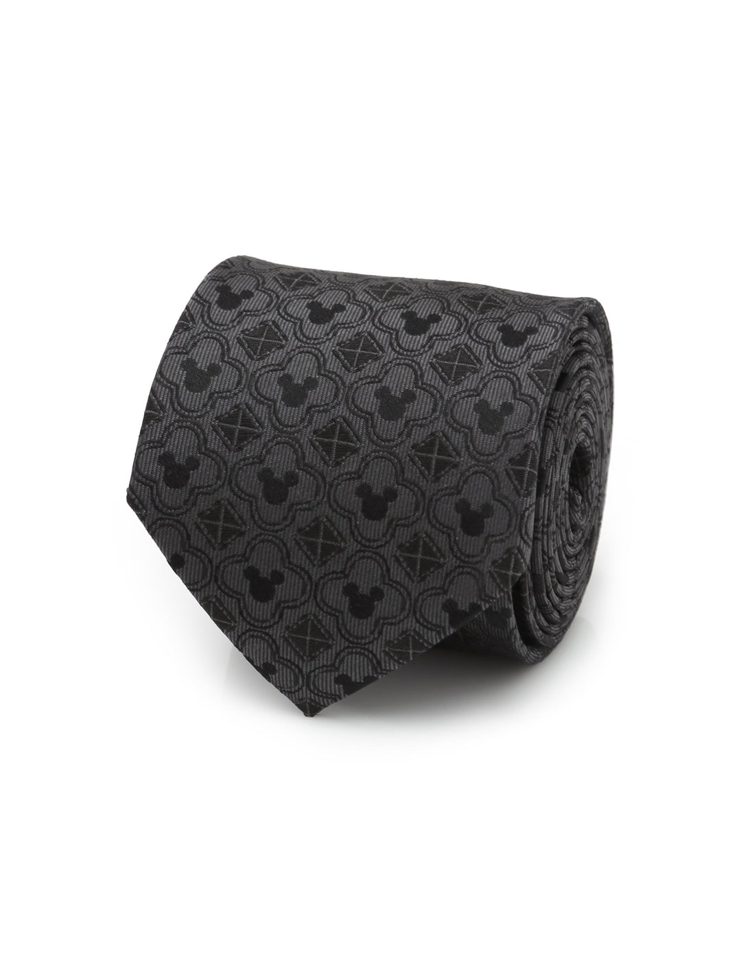 Disney Mickey Mouse Pattern Black Men’s Tie by Cufflinks.com, shown as a black silk necktie rolled into a coil with a repeating pattern of Mickey Mouse silhouettes and geometric shapes.