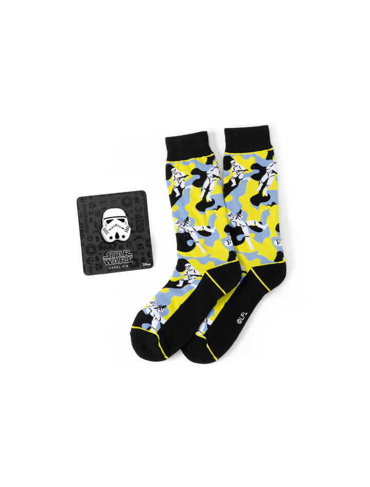 Star Wars Stormtrooper Yellow Camo Dress Socks and Lapel Pin Gift Set featuring camo-patterned socks with a yellow and light blue Stormtrooper print beside a square card with a matching lapel pin.