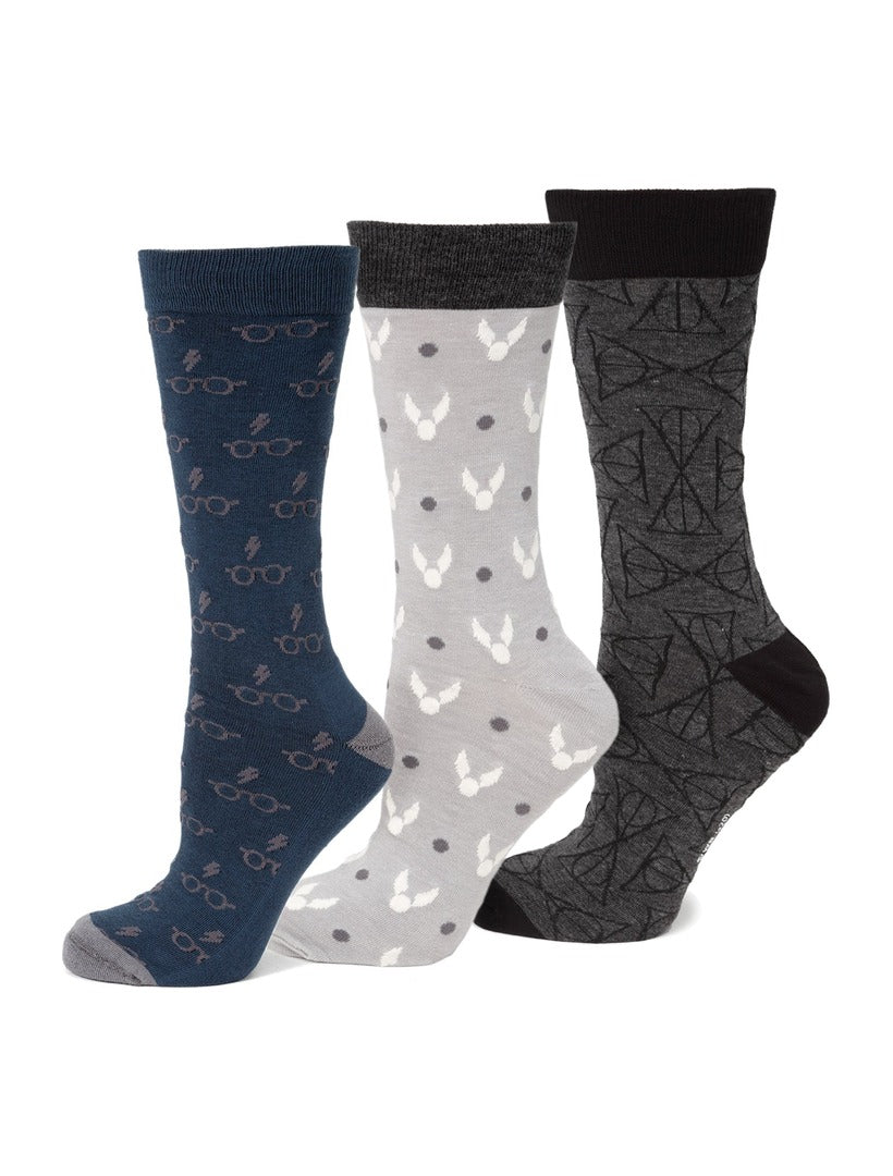 Harry Potter 3 Pack Sock Gift Set featuring blue socks with glasses and lightning bolts, light gray with golden snitches, and dark gray with the Deathly Hallows symbol.