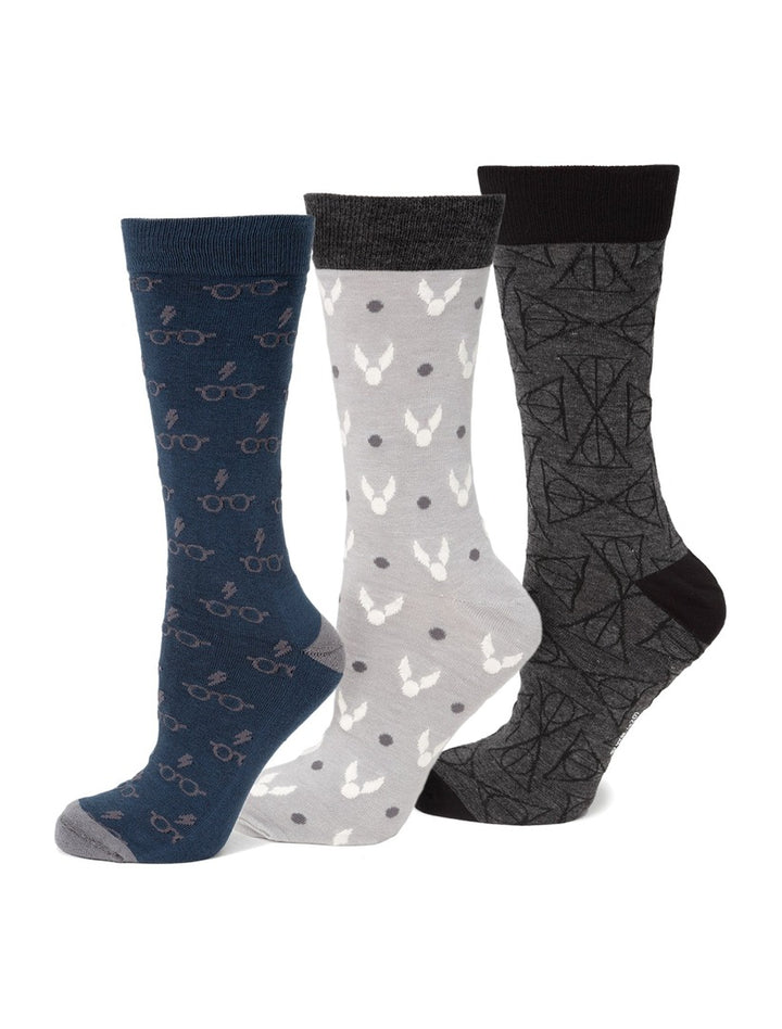 Harry Potter 3 Pack Sock Gift Set featuring blue socks with glasses and lightning bolts, light gray with golden snitches, and dark gray with the Deathly Hallows symbol.
