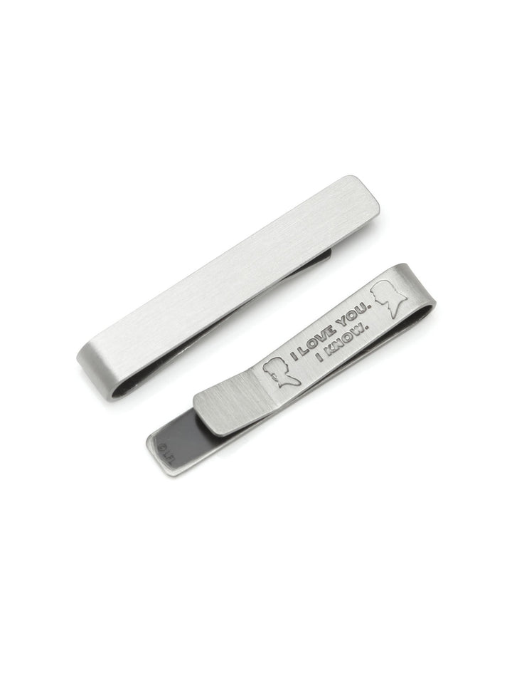 Two silver-toned Star Wars Princess Leia and Han Solo “I Love You / I Know” Hidden Message Tie Bar set, one plain and one engraved with silhouettes of Princess Leia and Han Solo.