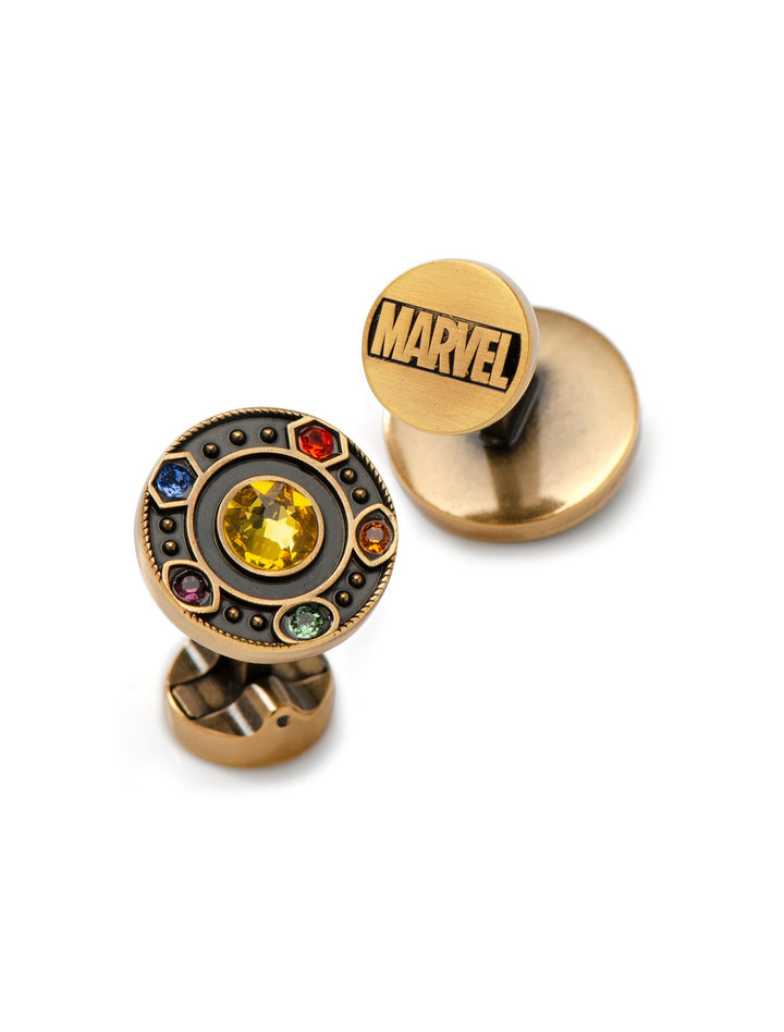 Marvel Avengers Infinity Stones Antique Gold Cufflinks featuring one piece with the word “MARVEL” and the other set with six colorful, circular Infinity Stone-inspired gems.