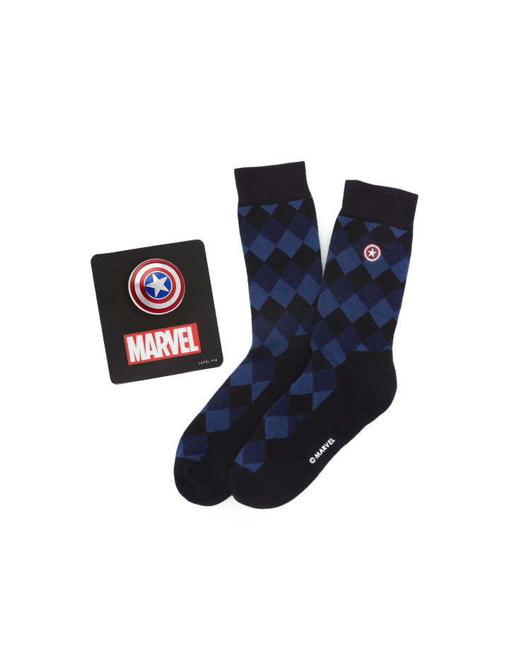 Blue and black argyle Captain America socks with a shield emblem, displayed next to a matching Captain America lapel pin from the Marvel Captain America Argyle Blue Gift Set by Cufflinks.com.
