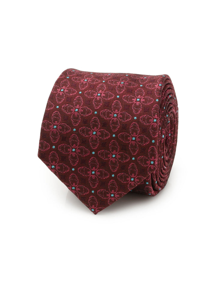 A rolled-up Marvel Iron Man Burgundy Multi Men’s Tie featuring a repeating pattern of masks and small light blue dots.