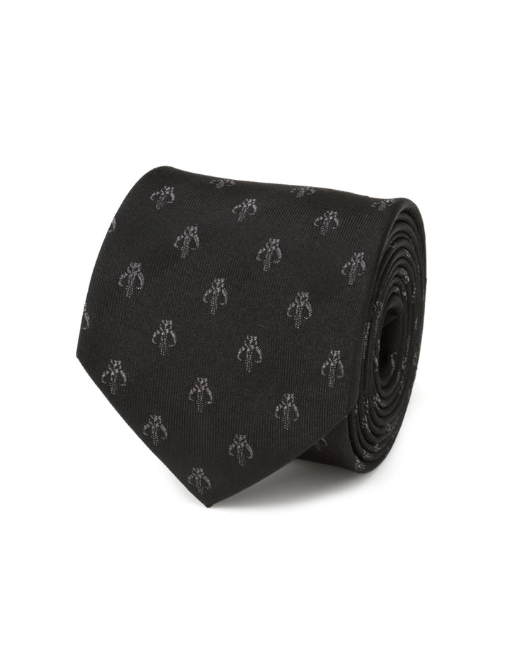 A black Star Wars Mandalorian Mythosaur Black Silk Tie rolled up and featuring a repeating pattern of grey Mandalorian Mythosaur skull icons.