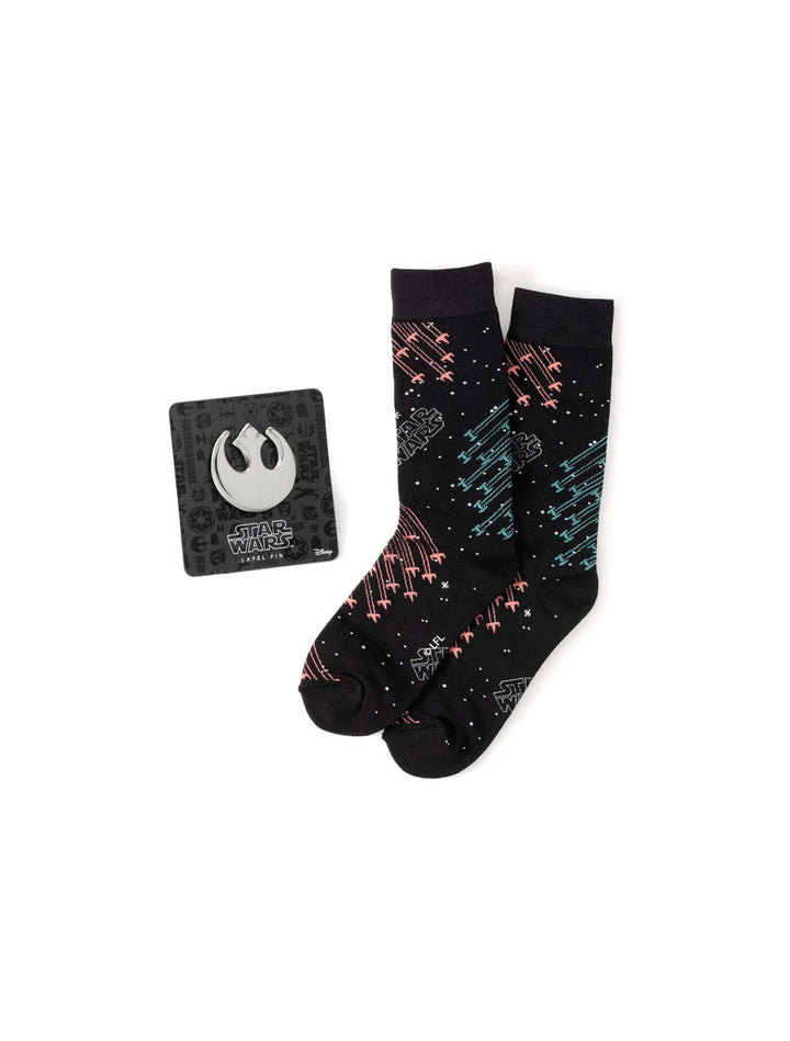 A pair of Star Wars X-Wing and TIE Fighter Battle Dress Socks and Lapel Pin Gift Set featuring a repeating X-wing and TIE fighter pattern, displayed with a circular silver Rebel Alliance lapel pin.