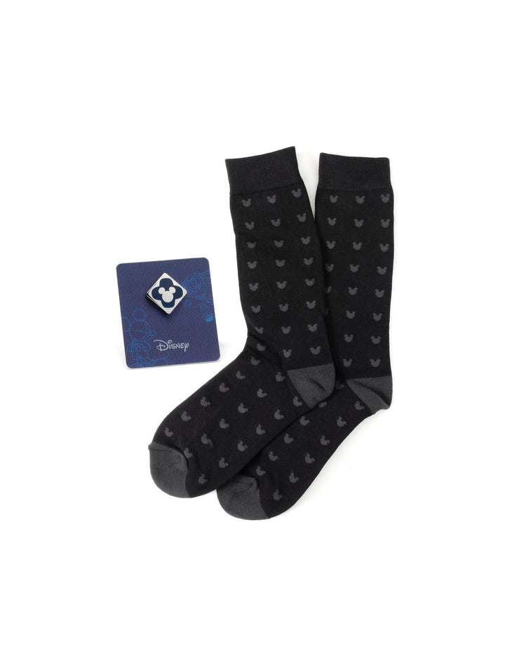 A Disney Mickey Mouse Silhouette Motif Black Sock and Mickey Blue Lapel Pin Gift Set featuring a repeating silhouette pattern on the socks and a matching lapel pin on a display card.