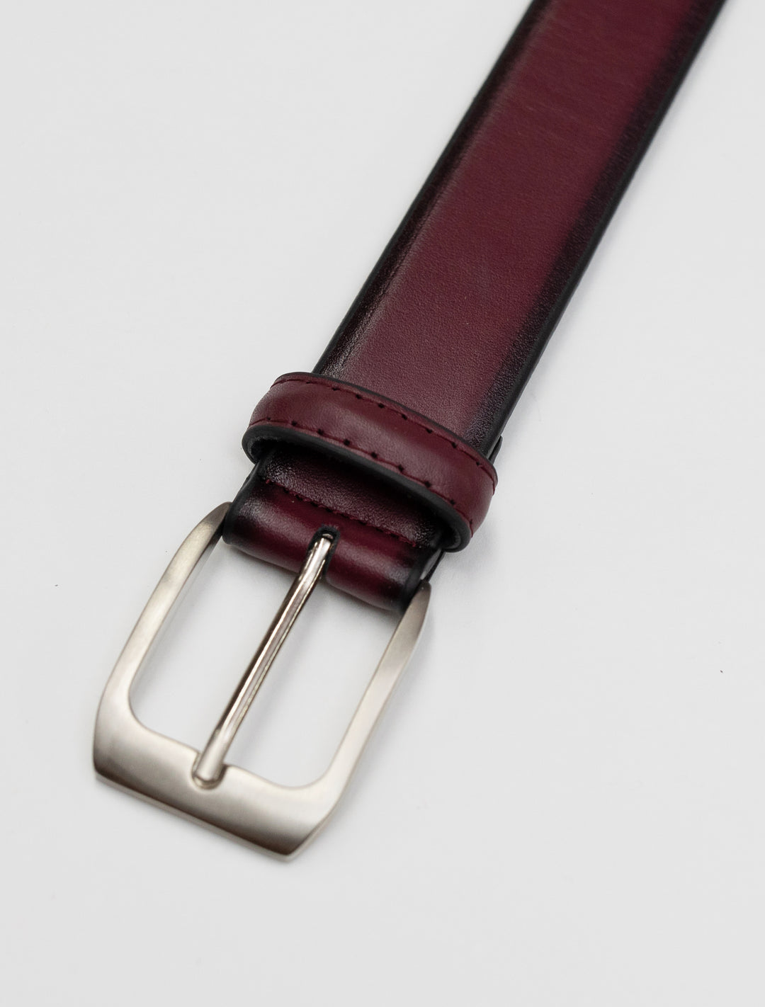 A Burgundy Waved Leather Frame Buckle Belt by Florsheim, perfect for waist sizes.
