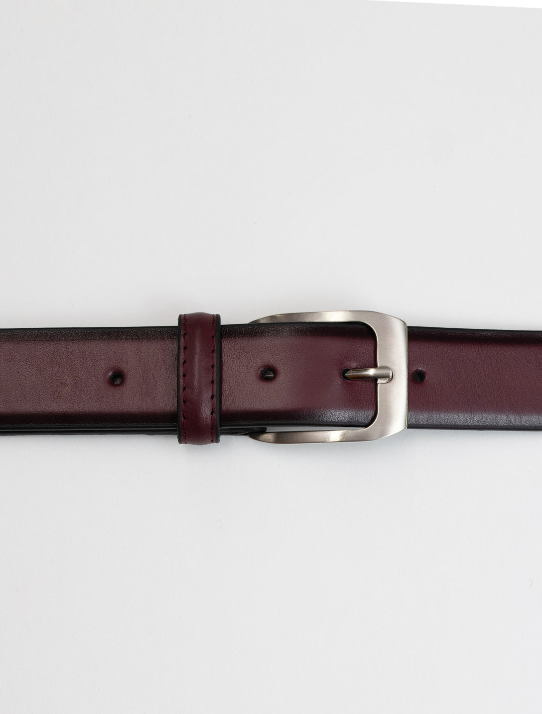 A Burgundy Waved Leather Frame Buckle Belt by Florsheim with a matte silver buckle.