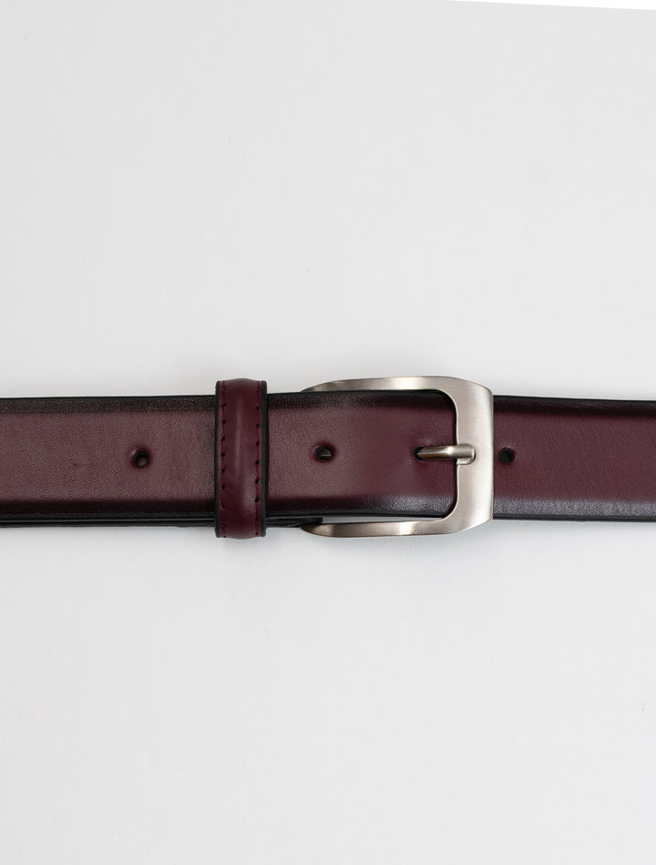 A Burgundy Waved Leather Frame Buckle Belt by Florsheim with a matte silver buckle.