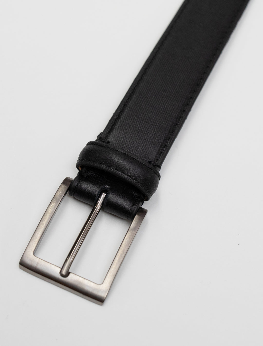 A stylish Black Stitch Edge Leather Frame Buckle Belt by Florsheim is displayed on a clean white surface.