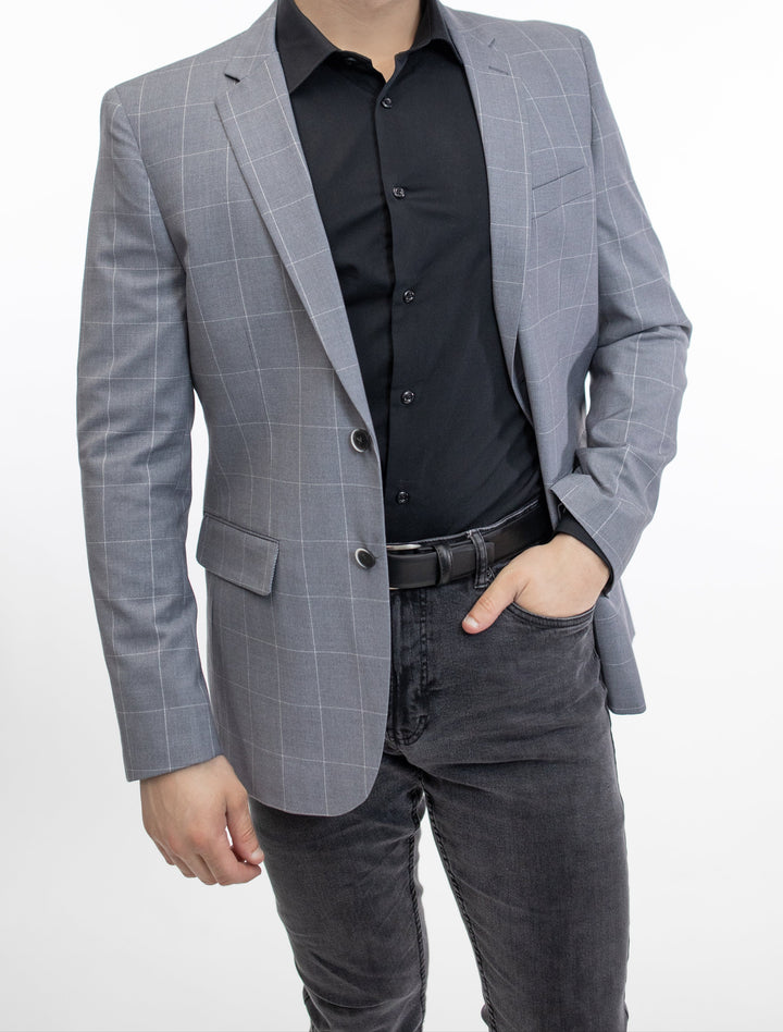 A slim fit man in a FUBU Slim Fit Light Grey Windowpane Sport Jacket posing for a photo.