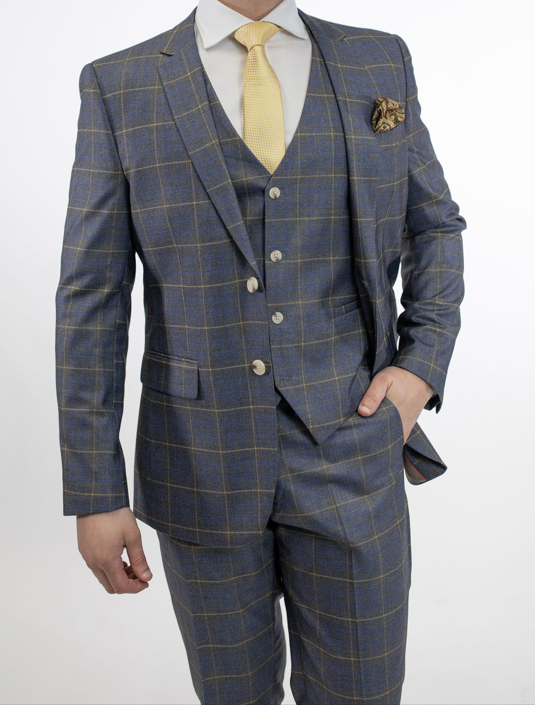 A man is posing in a FUBU Grey Madras Vested Suit by Fubu The Colle.