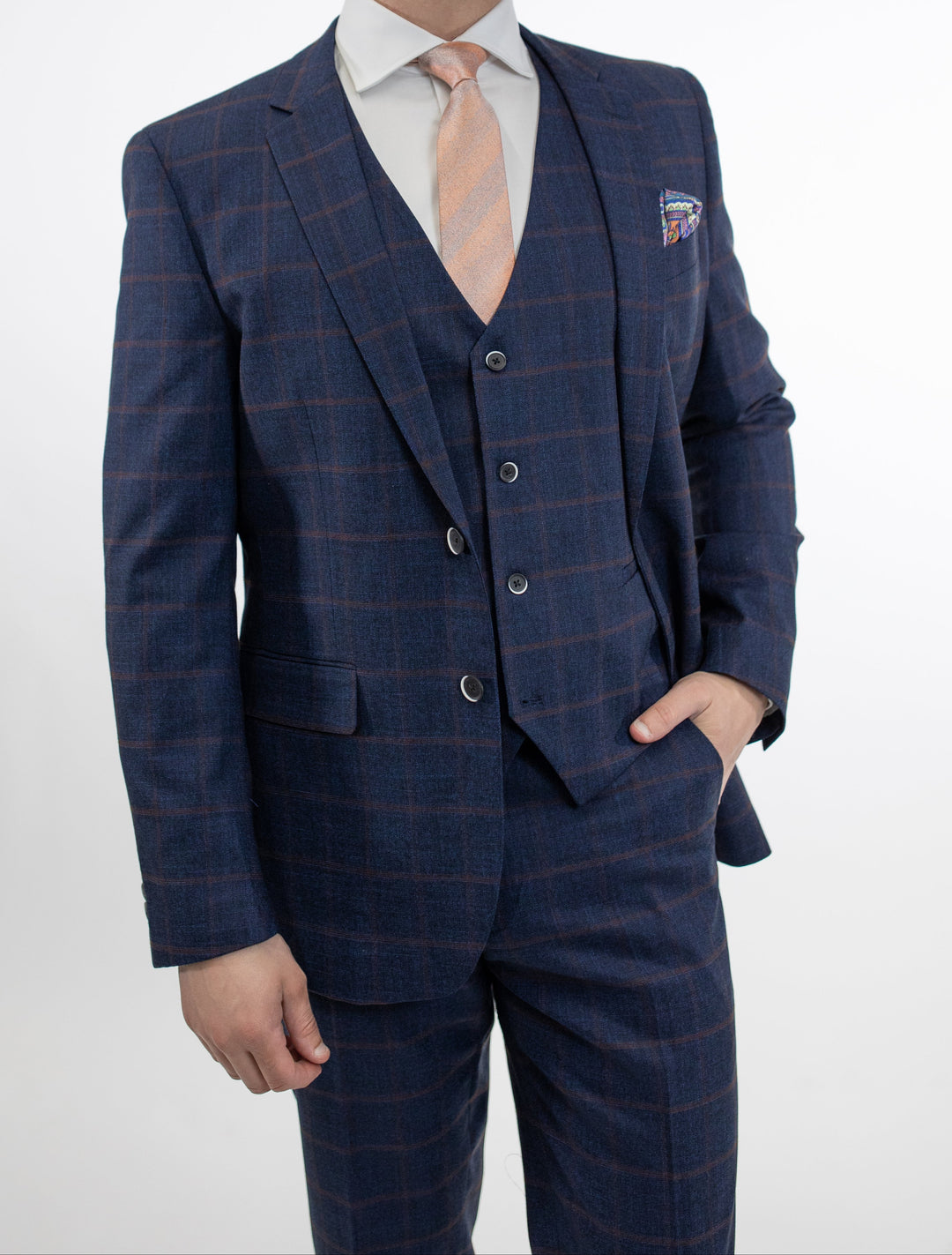 A man is posing in a FUBU Dark Blue and Burgundy Windowpane Vested Suit by Fubu The Colle.