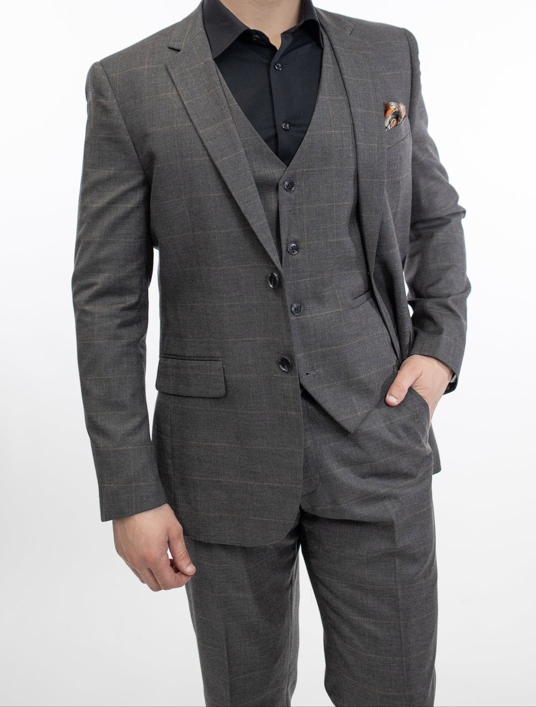 A man in a FUBU Charcoal Grey Windowpane Vested Suit by Fubu The Colle posing for a photo.